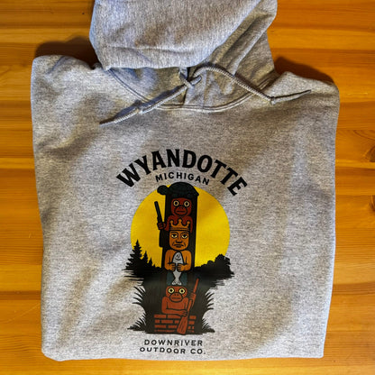 Gray hoodie with Wyandotte, Michigan design on a wooden surface